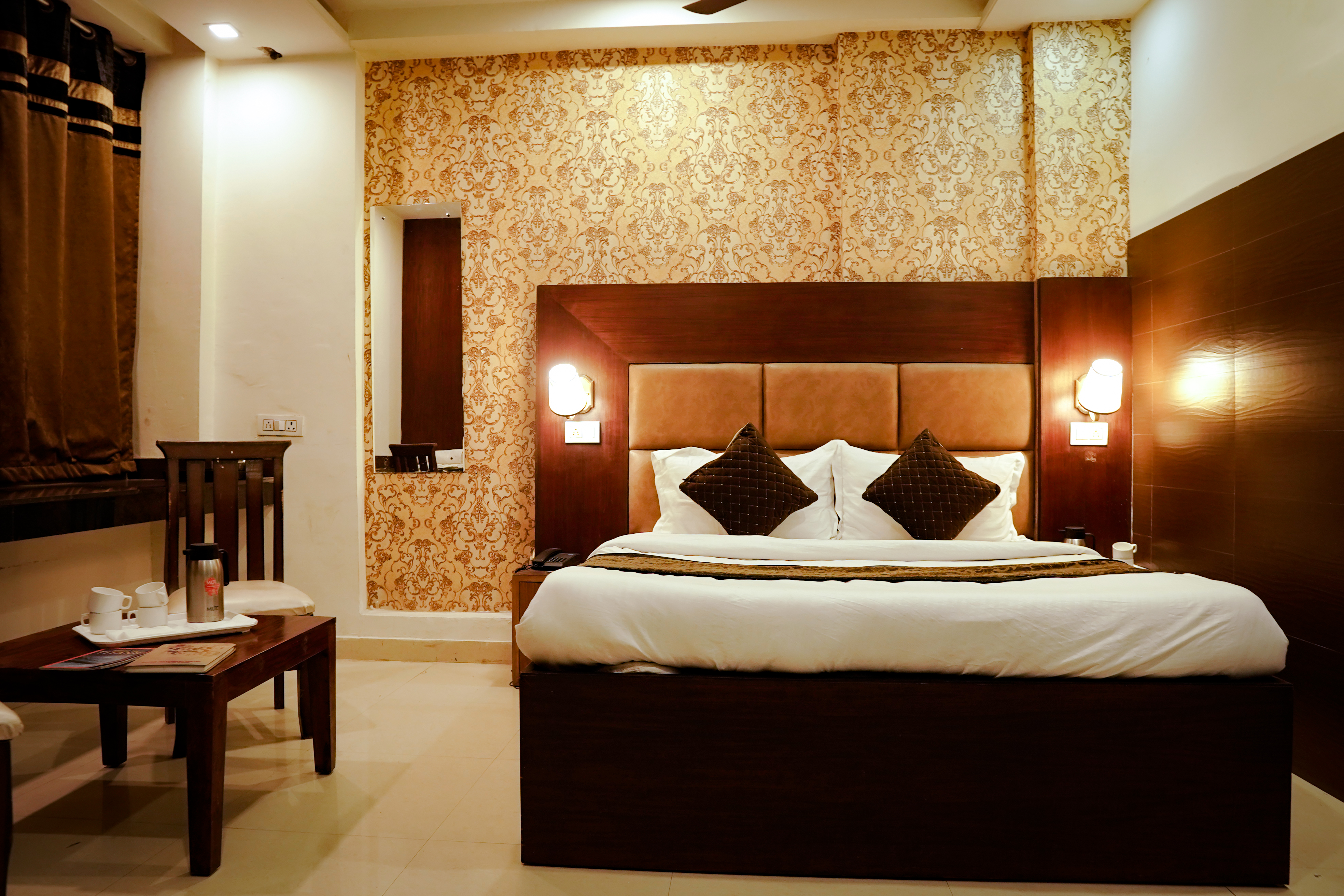 View of a clean and modern Deluxe Room at Hotel The Black Gold, featuring a 32-inch TV.